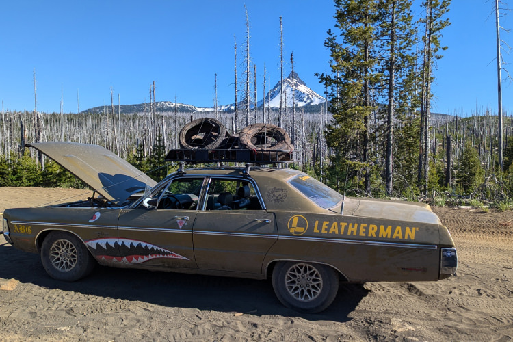 Leatherman customized car on the side of the road with hood up