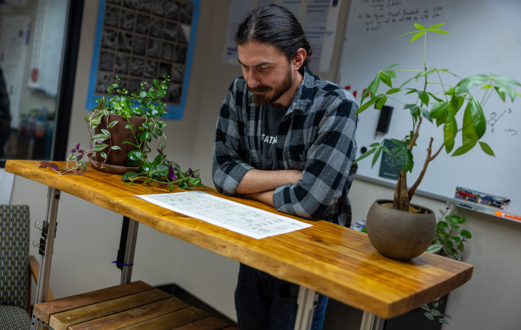 Seth at table reading a paper