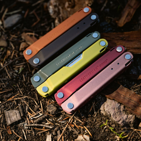 Three Leatherman Bond multi tools in various colors on the ground.