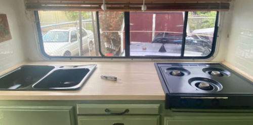 A camper countertop with a leatherman on top