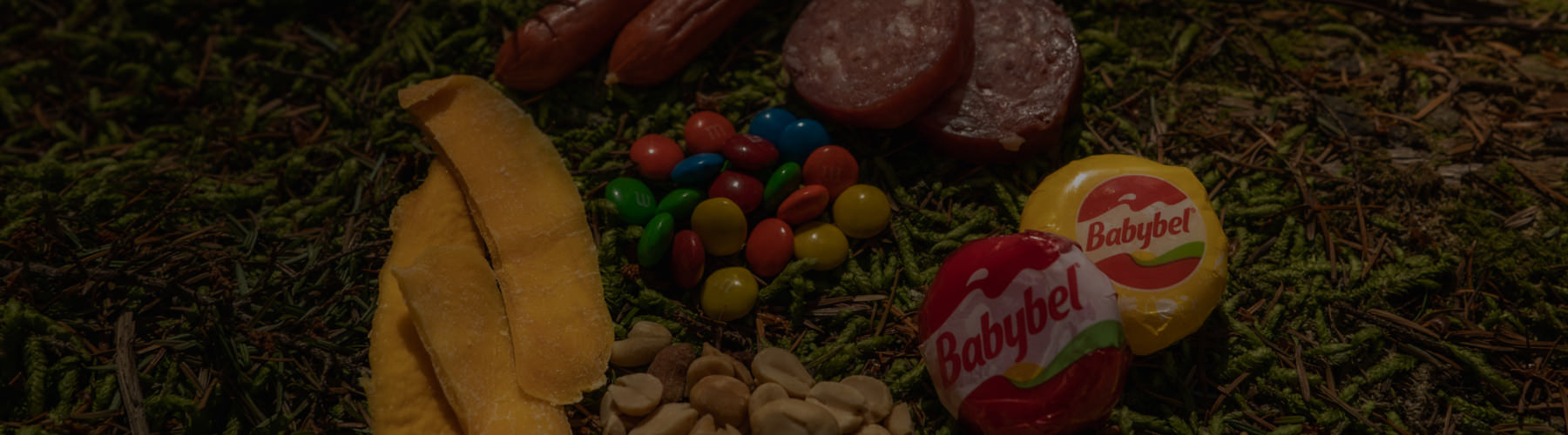 A colorful assortment of snacks and various items scattered on the ground, creating a vibrant and playful scene.