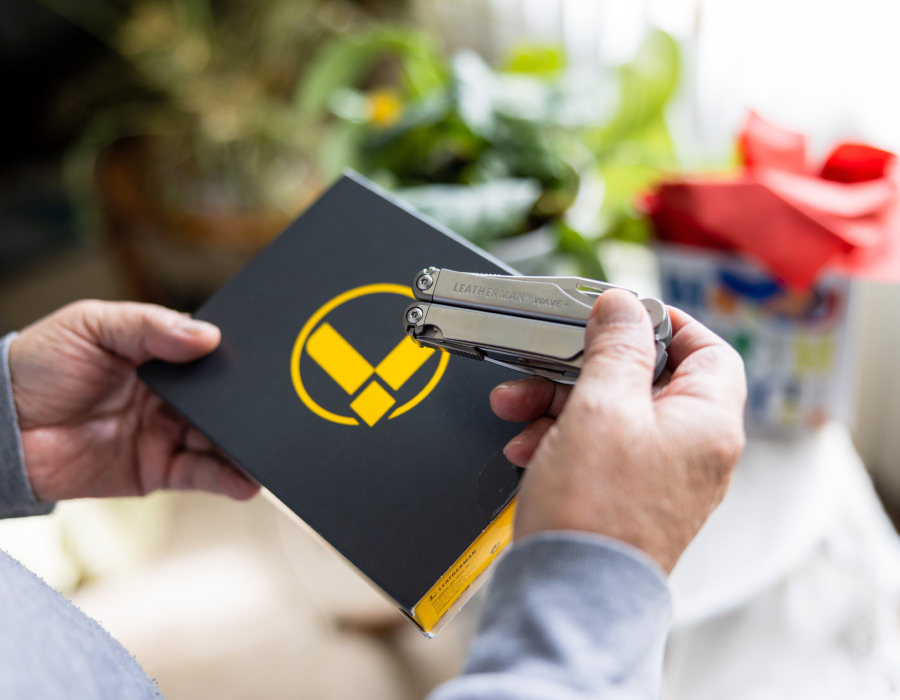 A man is holding Leatherman box, showcasing Leatherman Wave+.