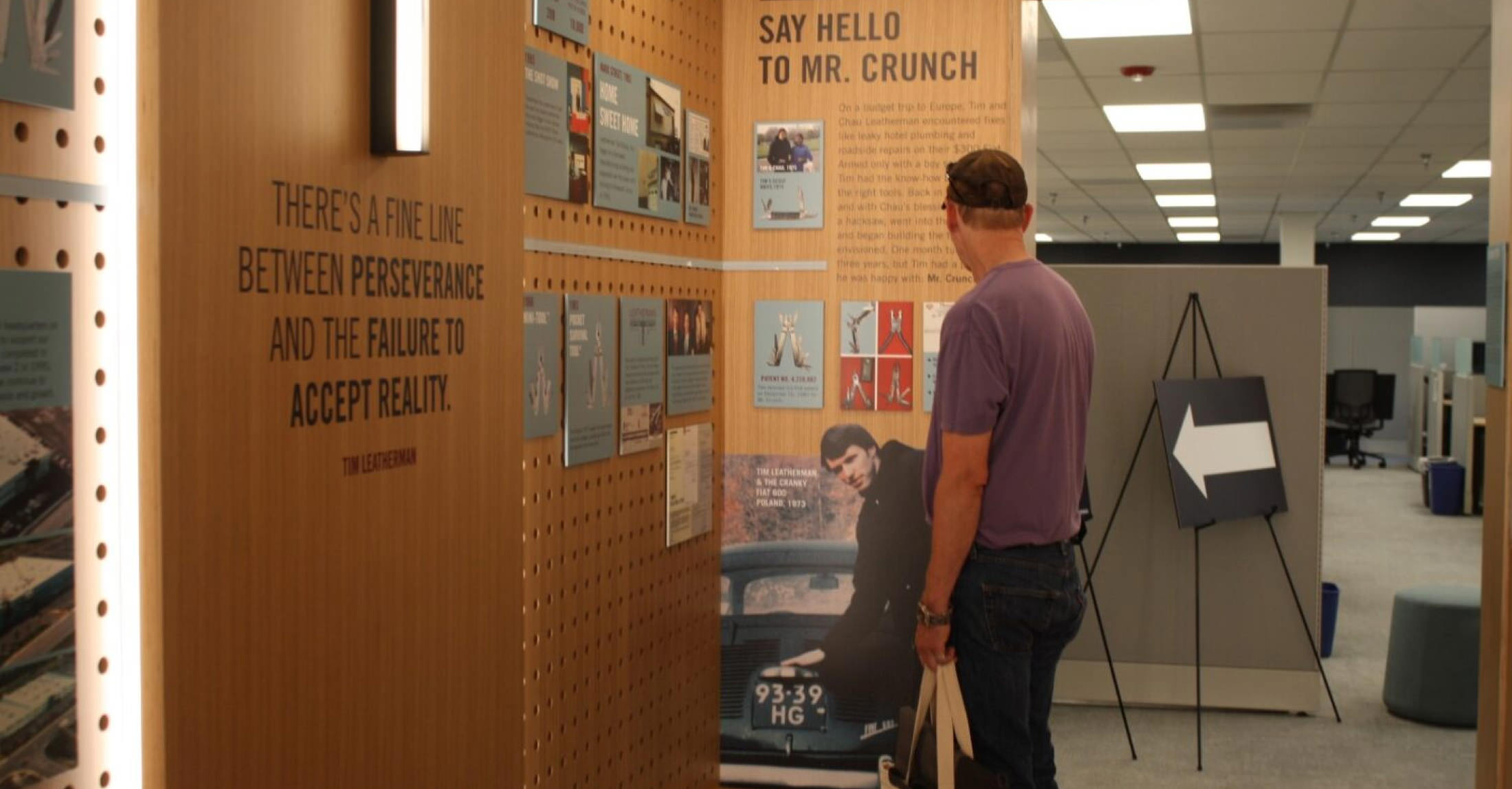 a man studies a display of information, showing interest in the data and visuals provided