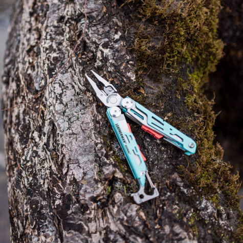 Leatherman Signal on a log.