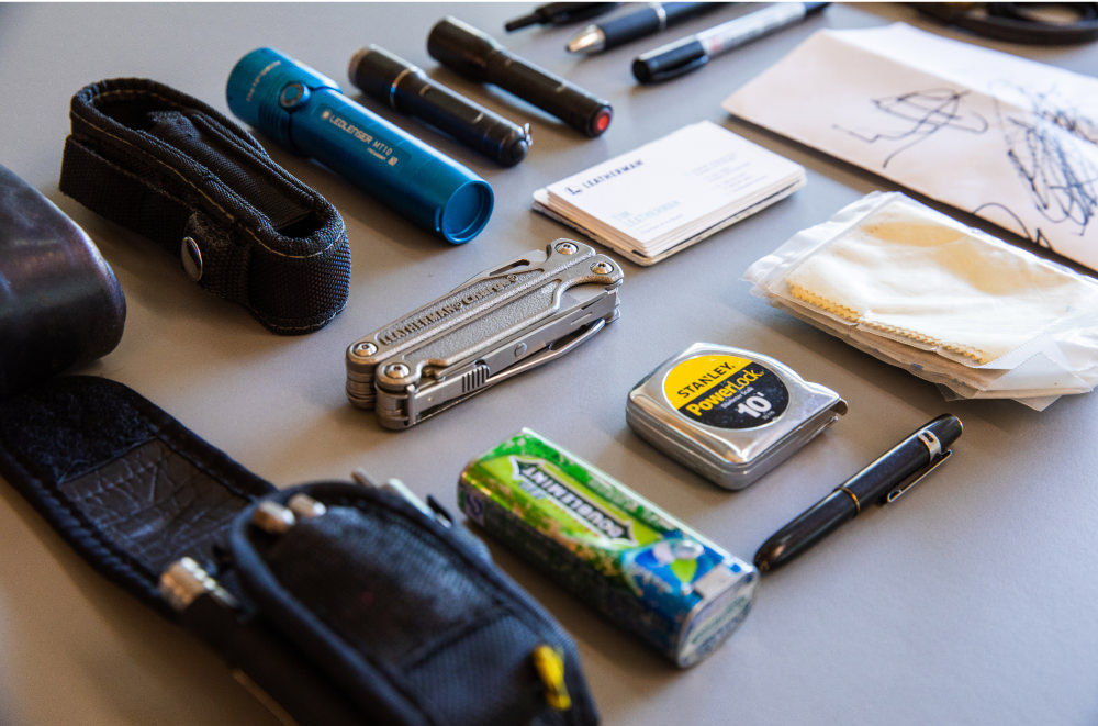 Leatherman Charge surrounded by various pocket tools, flashlights and pens.