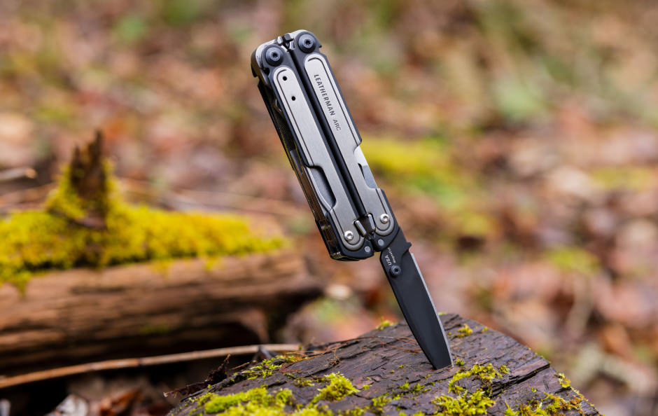 Leatherman ARC with blade in a log