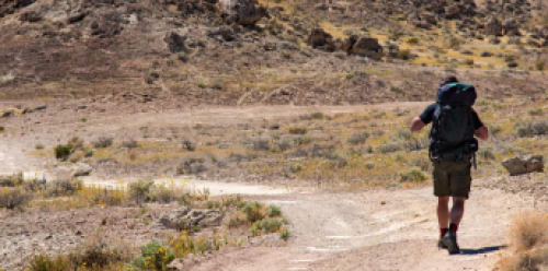 Hiker walking on a trail in the desert