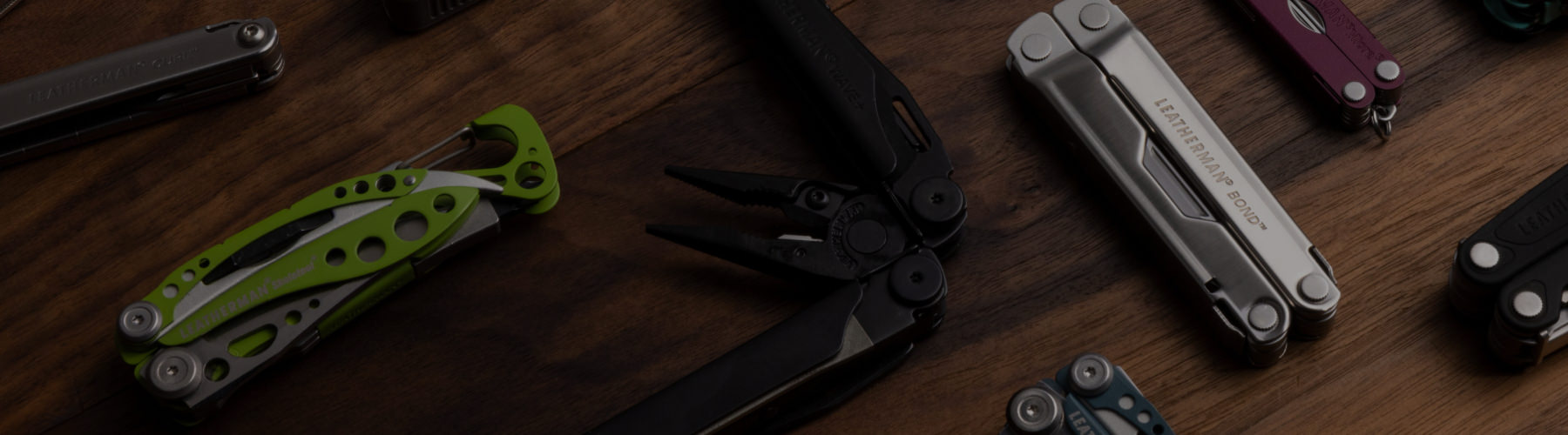 various multi-tools on a wooden table