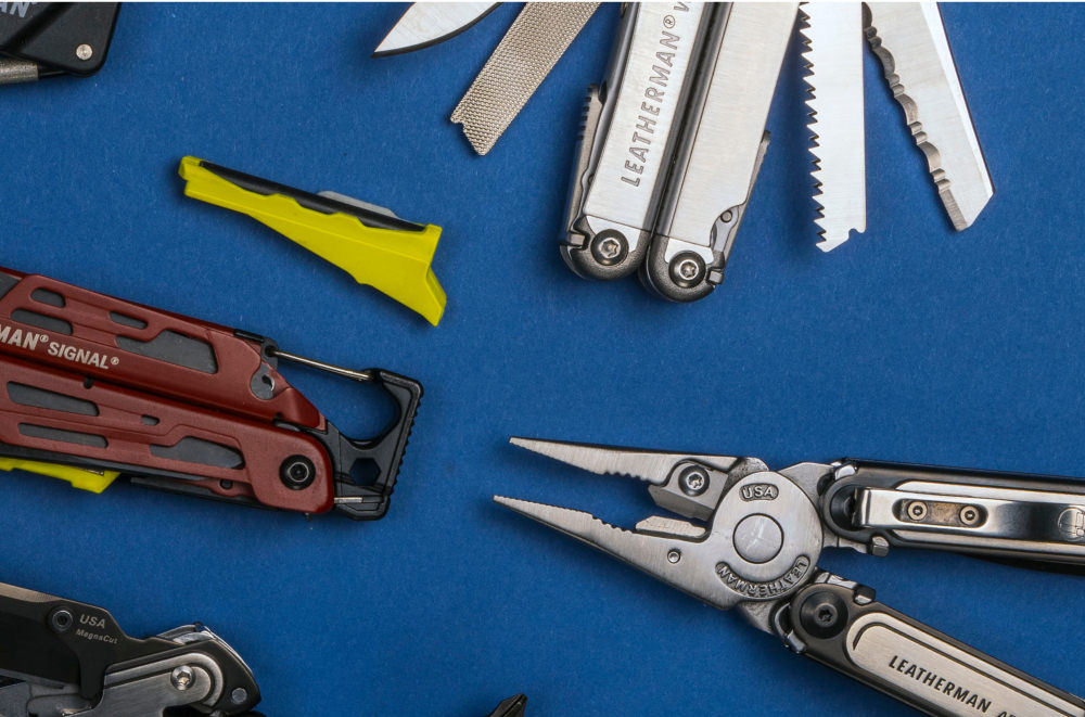 Various Leatherman tools on a blue background.