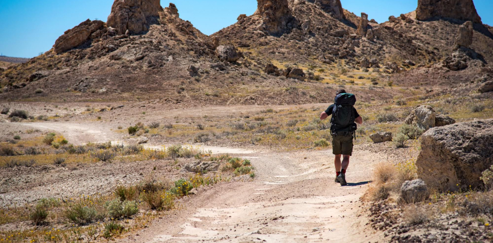 Hiker walking on a trail in the desert