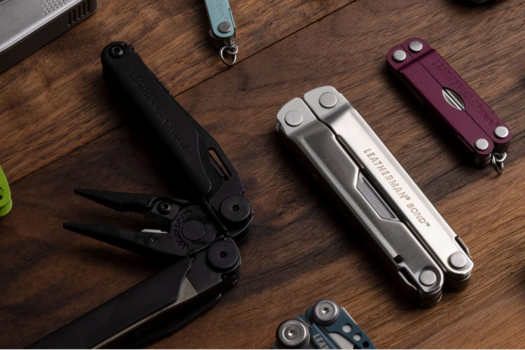 various multi-tools on a wooden table