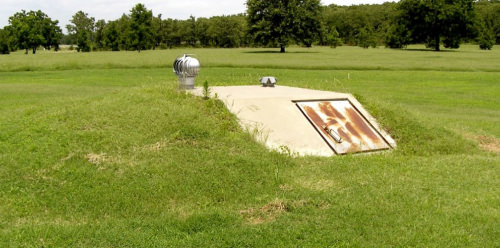 Survival bunker entrance in a grass field