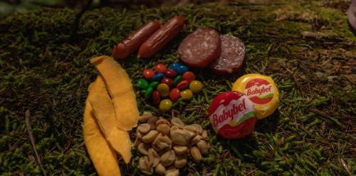 A colorful assortment of snacks and various items scattered on the ground, creating a vibrant and playful scene.