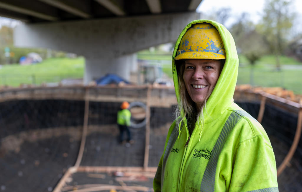 Woman with a hard hat and high visibility hoodie