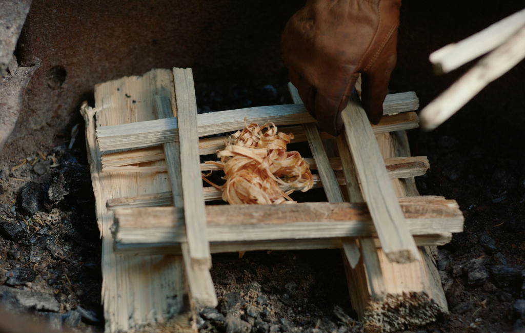 Log cabin style fire build with kindling in the center