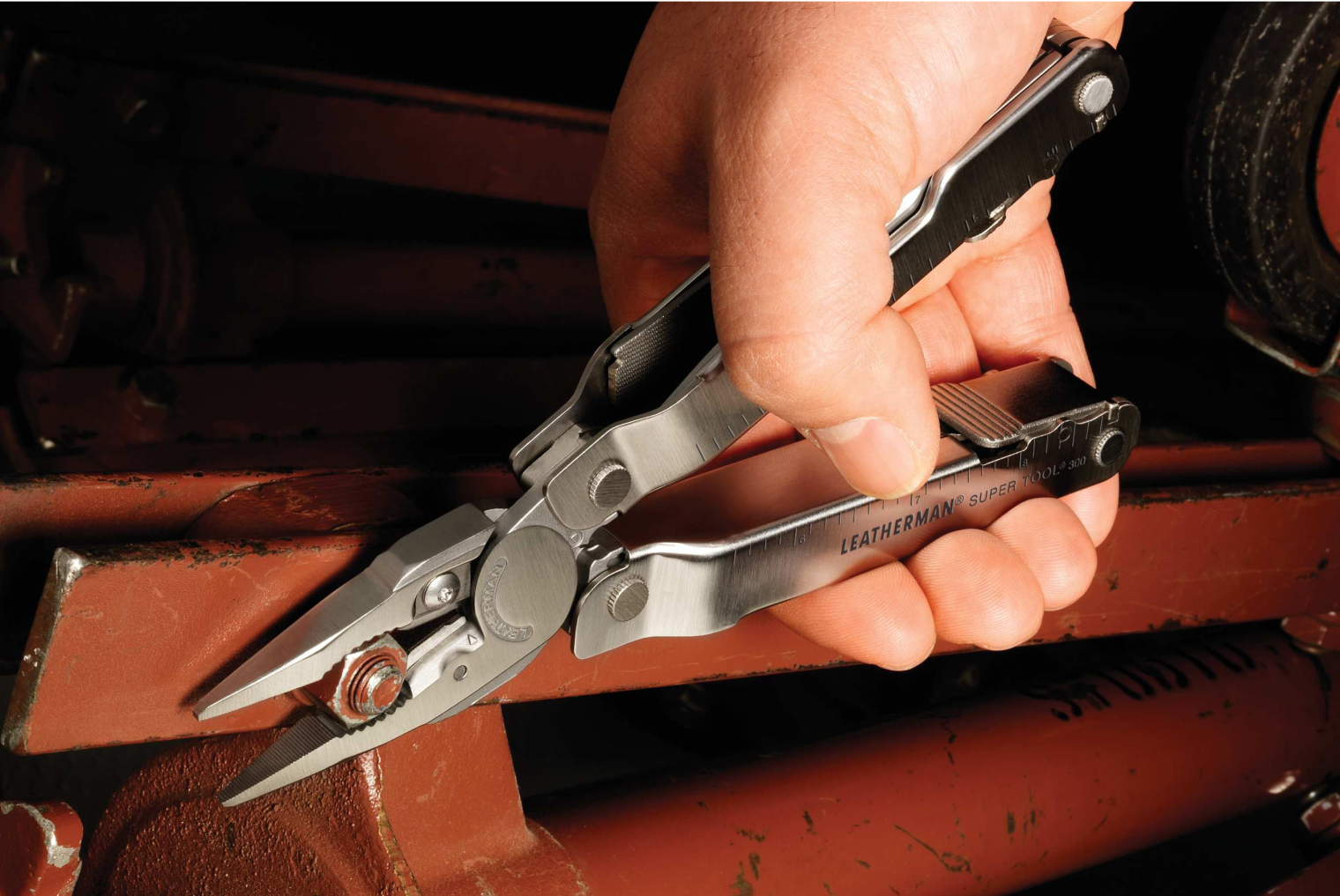 Leatherman Supertool being used to turn a nut