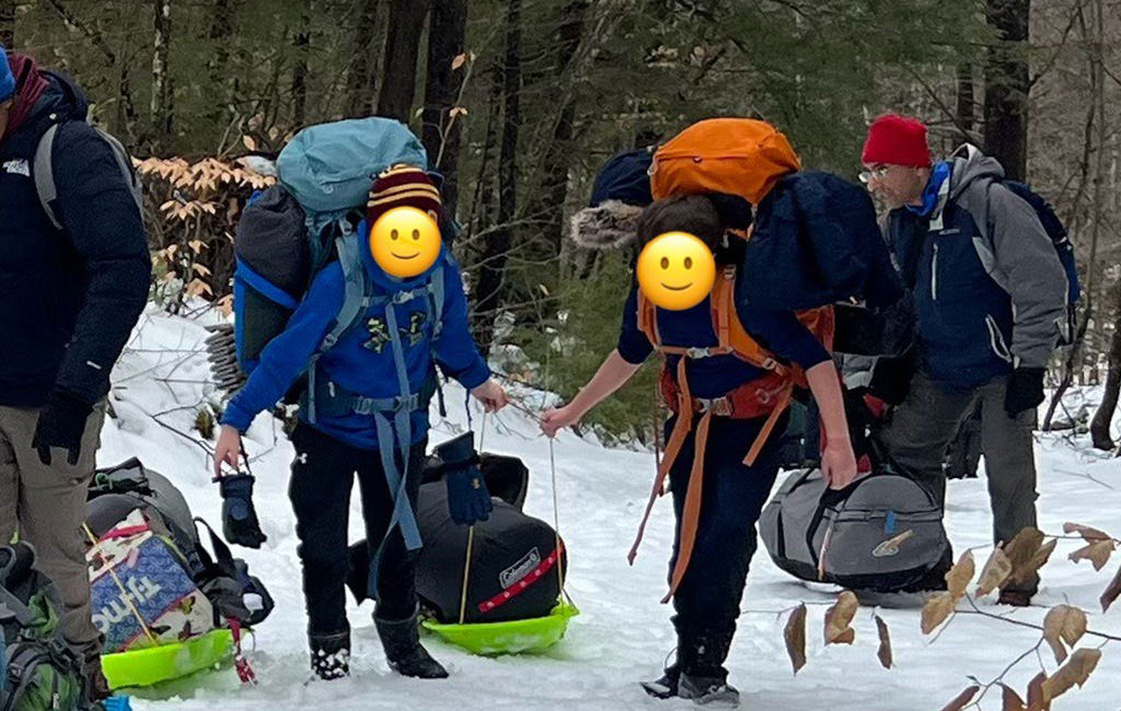 Group of people on a winter-snow camping trip.