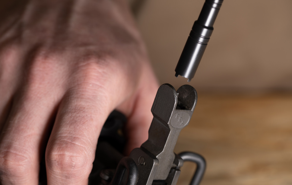 Someone using a Leatherman Sight Adjuster