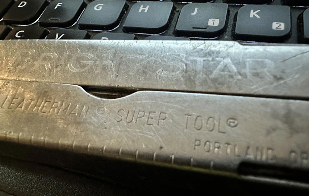 A Leatherman Supertool with special engraved on the handle.