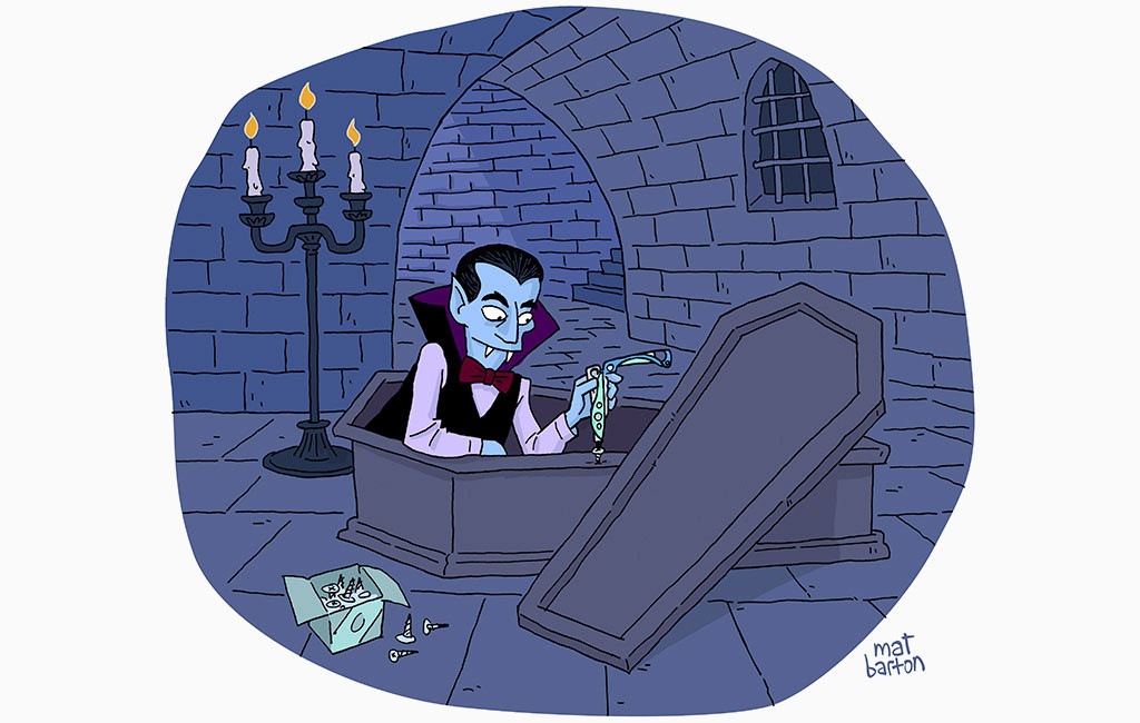 Dracula sitting in a coffin using a Skeletool CX to fix it.