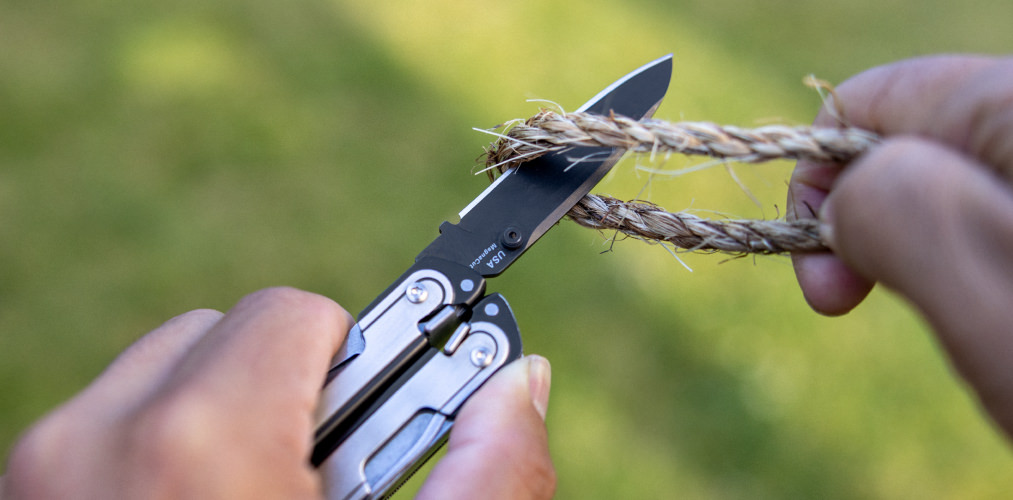 Person using an ARC blade to cut a rope.