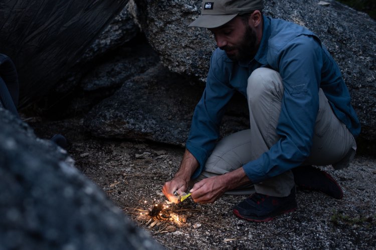 Signal ferrocerium rod being used to start a fire